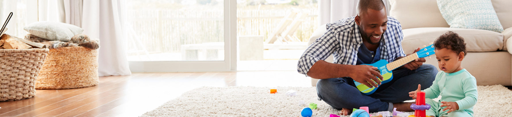 Man and child playing with toys in living room