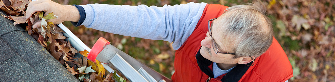 Man cleaning gutter