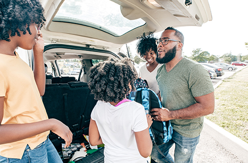 Family Packing Up Car